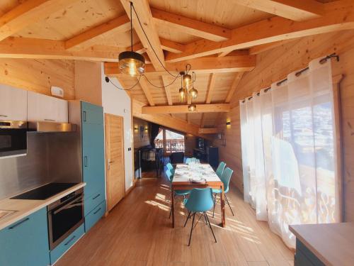 a kitchen and dining room with a table and chairs at Chalet Delphinette - Spa privatif in Morzine