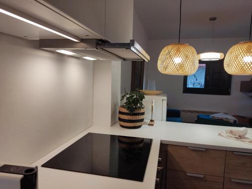 a kitchen with a counter top and two pendant lights at Peace & Beach House in Tihany, Sajkod in Tihany