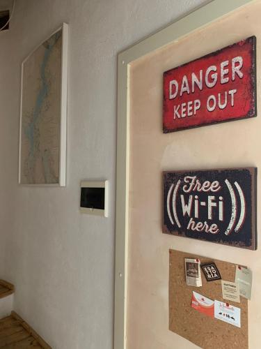 a sign on a wall that reads danger keep out tree wifi here at Casa Patrone in Nebbiuno
