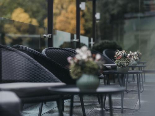 a row of tables with vases of flowers on them at VAYA Galtür Paznaun in Galtür