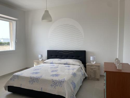 En eller flere senge i et værelse på La Torre - Piano terra By Cala Salento