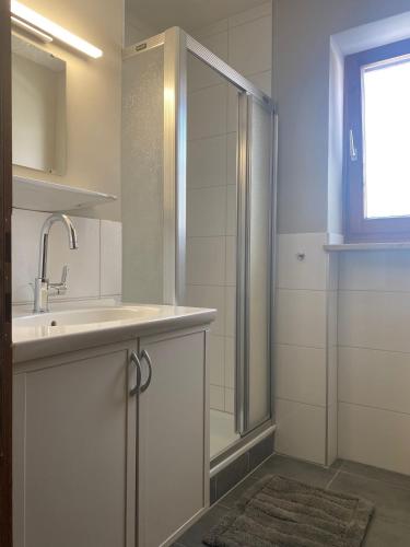 a bathroom with a shower and a sink at Gästehaus Johannes in Niedernsill
