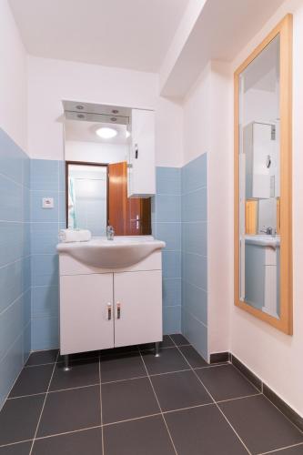 a bathroom with a sink and a mirror at Penzion Sykovec in Tři Studně