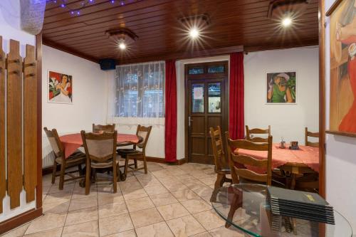 a dining room with a table and chairs at Penzion Sykovec in Tři Studně