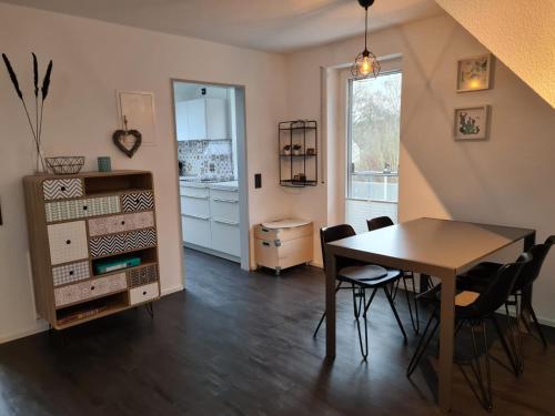 a dining room with a table and chairs and a window at Maisonette-Wohnung mit Balkon in Radolfzell am Bodensee