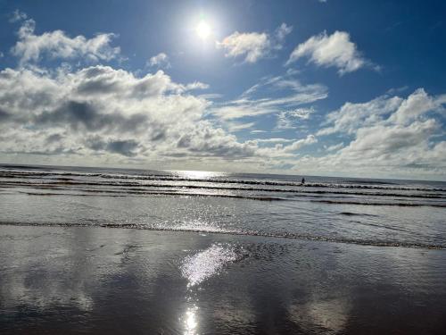 a beach with the sun reflecting on the wet sand at Kijani Paradise Malindi in Malindi