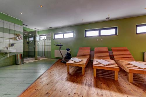 a room with chairs and a table and a bathroom at Apartmánový dom Slniečko in Žiar