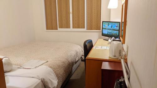 Postel nebo postele na pokoji v ubytování Ace Inn Kariya