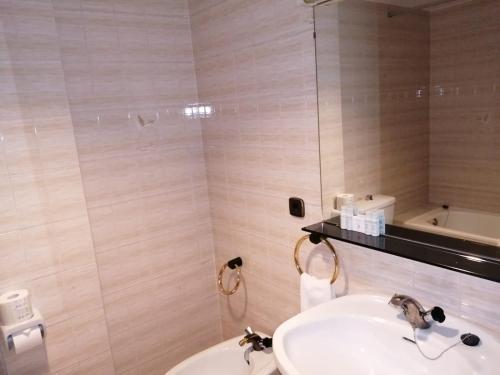 a bathroom with a sink and a toilet at HMC K-ena in Andorra la Vella