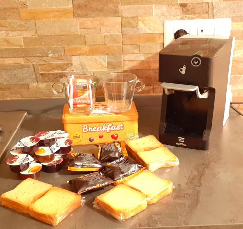 a table topped with cheese and a box of crackers at Casa vacanze Perfecta Laetitia Assisi in Tordandrea