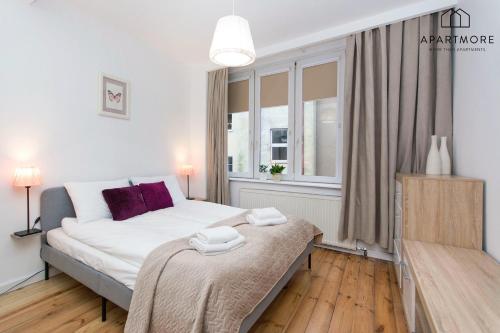 a bedroom with a bed and a window at Old Town by Apartmore in Gdańsk