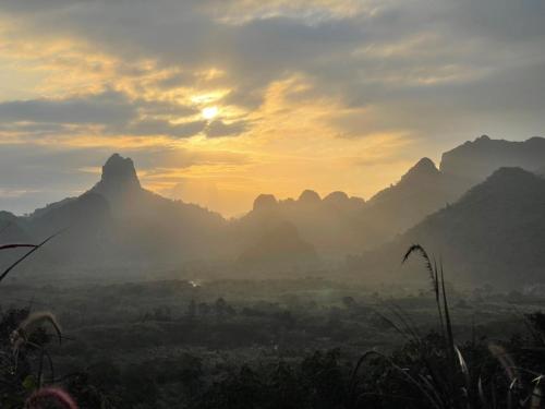 a view of a valley with mountains in the background at Por Sampao Camp&Resort in Ban Pha Saeng Lang