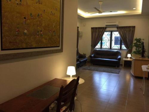 a living room with a table and a couch at MELAKA BEACH VILLA ( B TYPE ) in Melaka