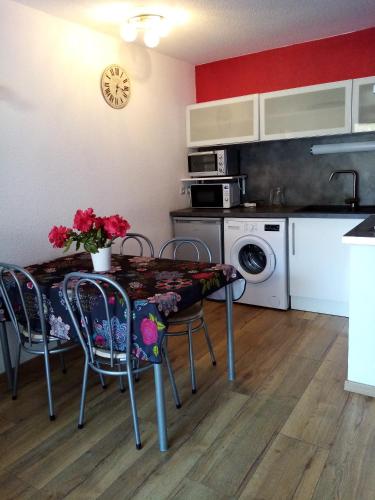 a kitchen with a table and chairs in a kitchen at DIGNE LES BAINS in Digne-les-Bains