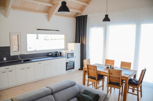 a kitchen and dining room with a table and a couch at Slonovy CHaty in Dolní Morava