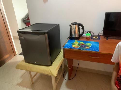 a television sitting on a chair next to a desk at Villa DeLorenta in Anuradhapura