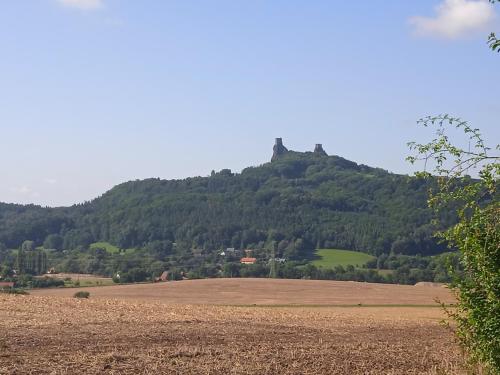 a hill with a castle on top of it at apartman17 in Syřenov