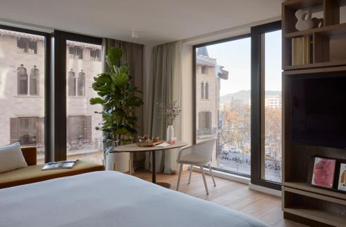 a hotel room with a bed and a large window at ME Barcelona in Barcelona
