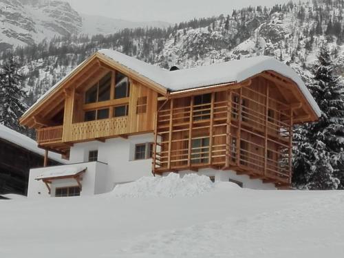 a house on top of a snow covered mountain at Cosy Winter - Luxury Chalet at the foot of the Dolomites in La Villa
