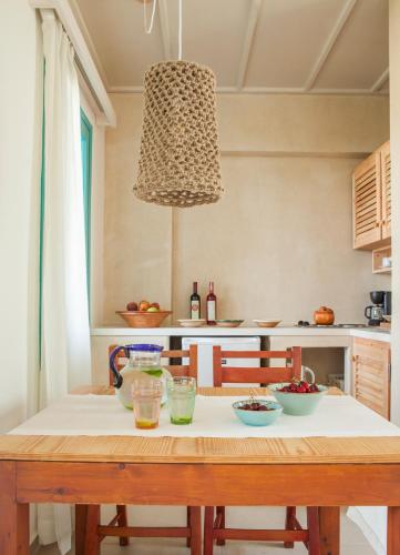 a kitchen with a wooden table and aendant light at Villa Iokasti in Hersonissos