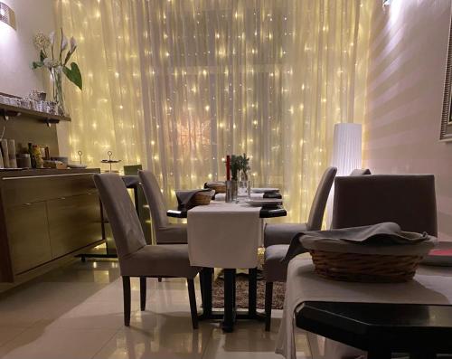 a dining room with a table and chairs with lights at Penzion Luxor in Trnava