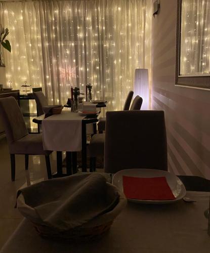 a dining room with a table and chairs and lights at Penzion Luxor in Trnava