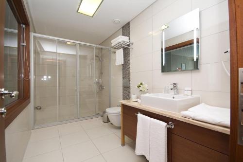 a bathroom with a shower and a sink and a toilet at Innpera Hotel in Istanbul