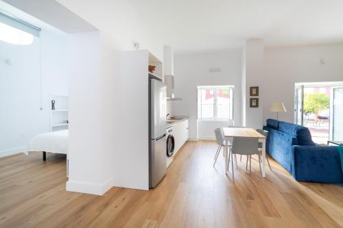 a living room with a blue couch and a table at Albor Suites in Santa Brígida