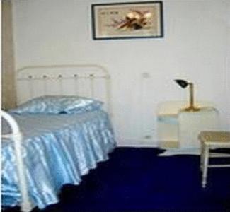a bedroom with a bed and a table with a lamp at Lalobema in Machecoul