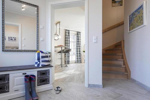 a hallway with a mirror and a staircase in a house at Holiday house, Fuhlendorf in Fuhlendorf