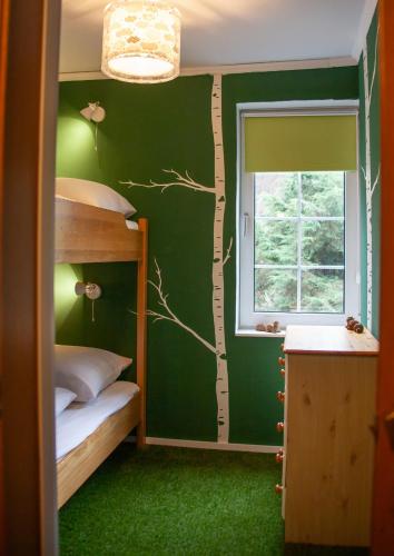 a room with two bunk beds and a window at Waldhaus Wolfsbachmühle in Hohegeiß
