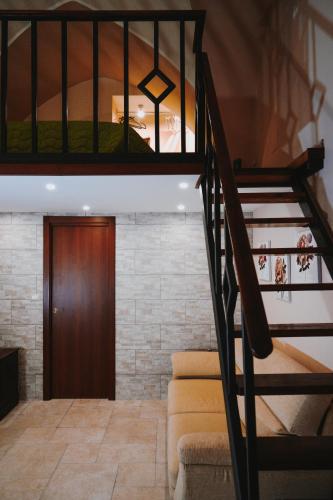 a spiral staircase in a house with a wooden door at Civico 9 in Brindisi