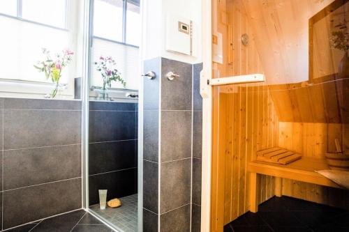 a shower with a glass door in a bathroom at Holiday house, Fuhlendorf in Fuhlendorf
