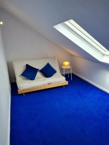 a room with a bed with blue carpet and a window at Entire Premium Holiday Cottage in Monkwearmouth