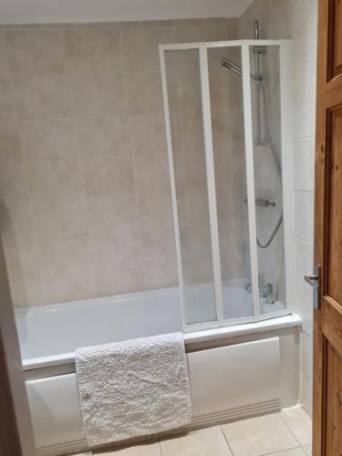 a shower with a glass door in a bathroom at Entire Premium Holiday Cottage in Monkwearmouth