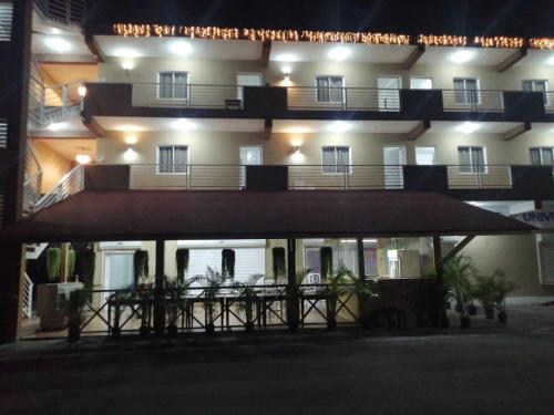 a building with a balcony with lights on it at My Home Hotel Punta Cana in Punta Cana