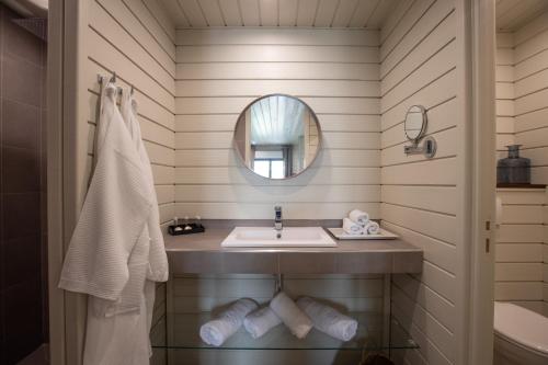 a bathroom with a sink and a mirror at Blue Sail Hotel in Anse Marcel 