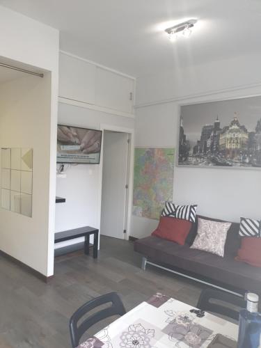 a living room with a couch and a table at Bonito Apto Barrio del Pilar Smart Fit in Madrid