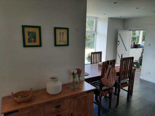 a kitchen and dining room with a table and chairs at Quintessential, secluded South Devon cottage in Plymouth