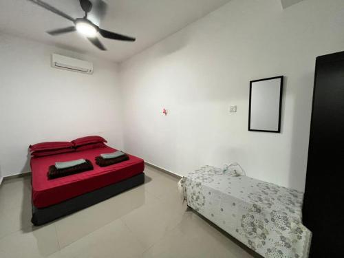 a white room with a red bed and a couch at D TETAMU Bandar Sg Long in Kajang