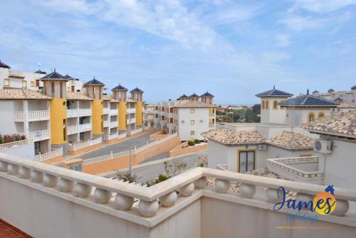 a view of a city from a balcony at Playa Golf Quad House with Communal Pool Calle Castillo de San Roque P231 in Orihuela