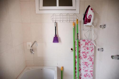 a bathroom with a shower curtain and a sink at Flats Martinez in Conservatória