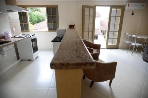 a kitchen with a granite counter top in a room at Flats Martinez in Conservatória