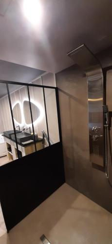 a small bathroom with a sink and a mirror at EnTerrasse 4 étoiles in Dinan