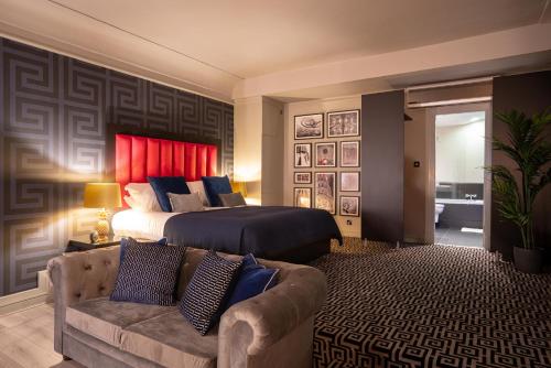 a hotel room with a bed and a couch at 62 Castle Street Hotel in Liverpool