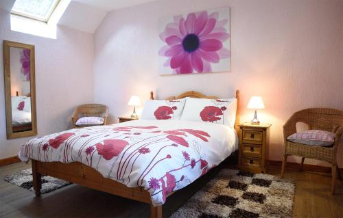 a bedroom with a bed with a flower painting on the wall at Bramble Cottage in Ollach