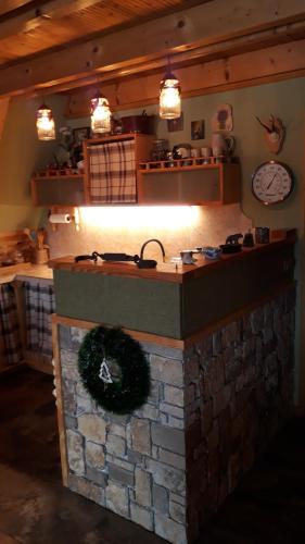 a kitchen with a brick oven with a wreath on it at Tarski Proplanak in Bajina Bašta