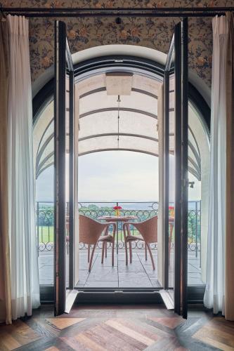 an open door to a patio with a table at The Dolder Grand - City and Spa Resort Zurich in Zürich