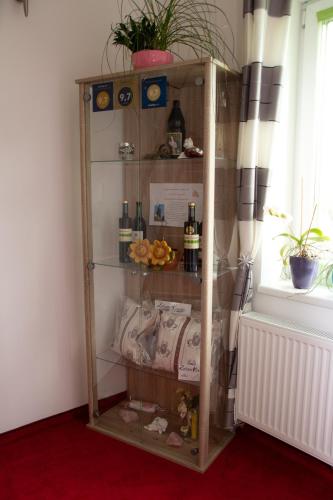 a wooden shelf with bottles on it next to a window at Die Schlafstube - Bed & Breakfast in Zeltweg