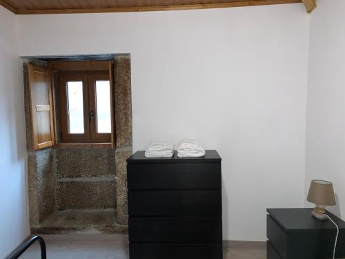 a pair of shoes sitting on a dresser in front of a door at Casa do Julien Mountain Experience in Vila Real